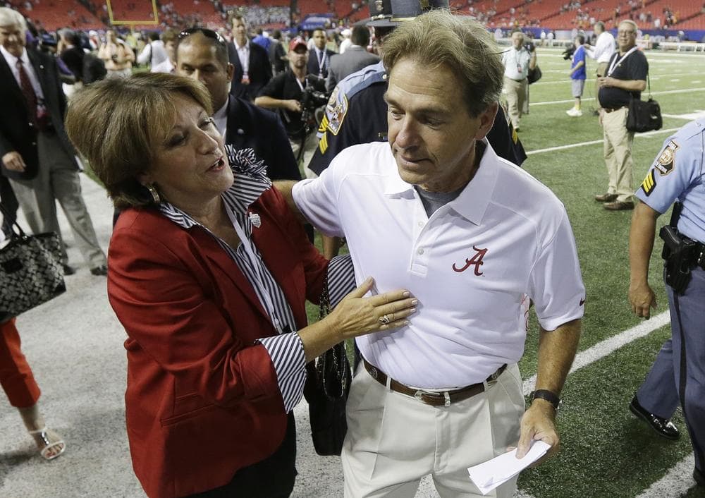Alabama head coach Nick Saban gets a hug from his wife, Terry. (Dave Martin/AP) 