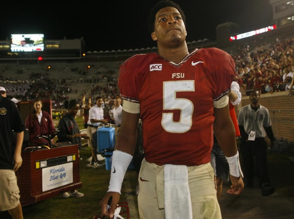 Florida State quarterback Jameis Winston is the top candidate for the Heisman Trophy. He's also under investigation for sexual assault. (Phil Sears/AP)
