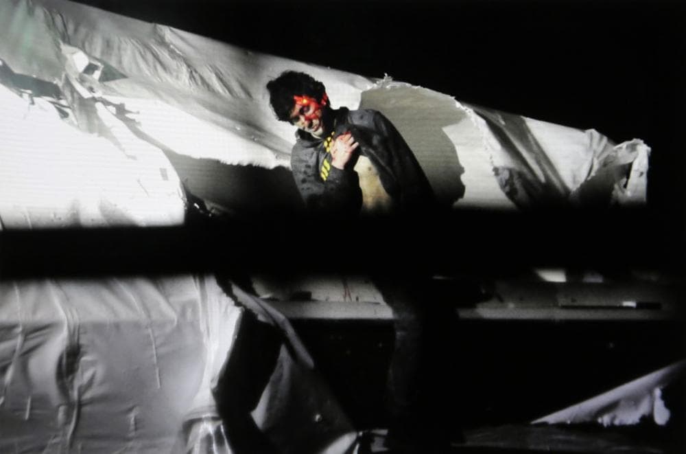 In this Friday, April 19, 2013 Massachusetts State Police photo, 19-year-old Boston Marathon bombing suspect Dzhokhar Tsarnaev leans over in a boat at the time of his capture by law enforcement authorities in Watertown, Mass. (AP Photo/Massachusetts State Police, Sean Murphy)