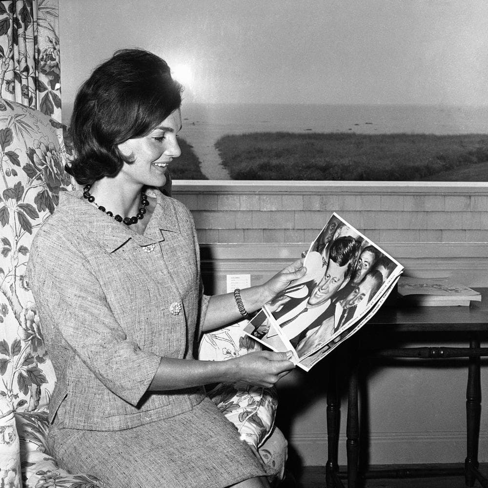 Jackie Kennedy looks at photos showing her husband, John F. Kennedy, at the Democratic Convention. (AP/Bill Chaplis)
