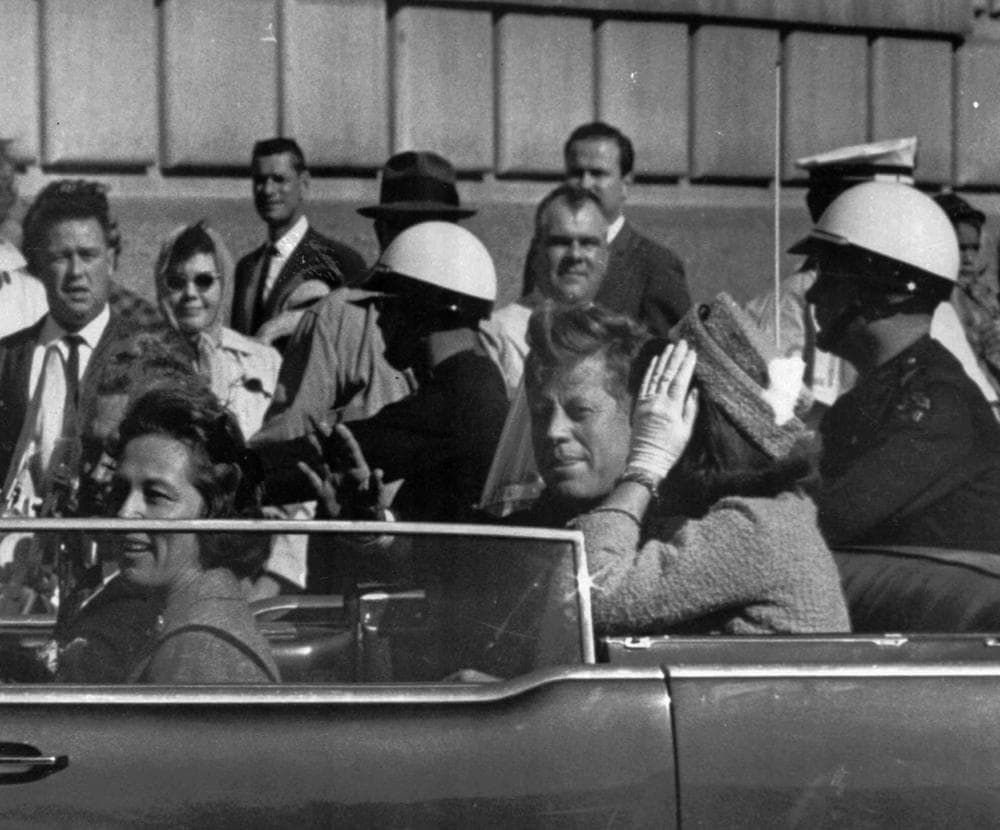 President John F. Kennedy rides in a motorcade with his wife Jackie moments before he was shot and killed in Dallas, TX. (AP)