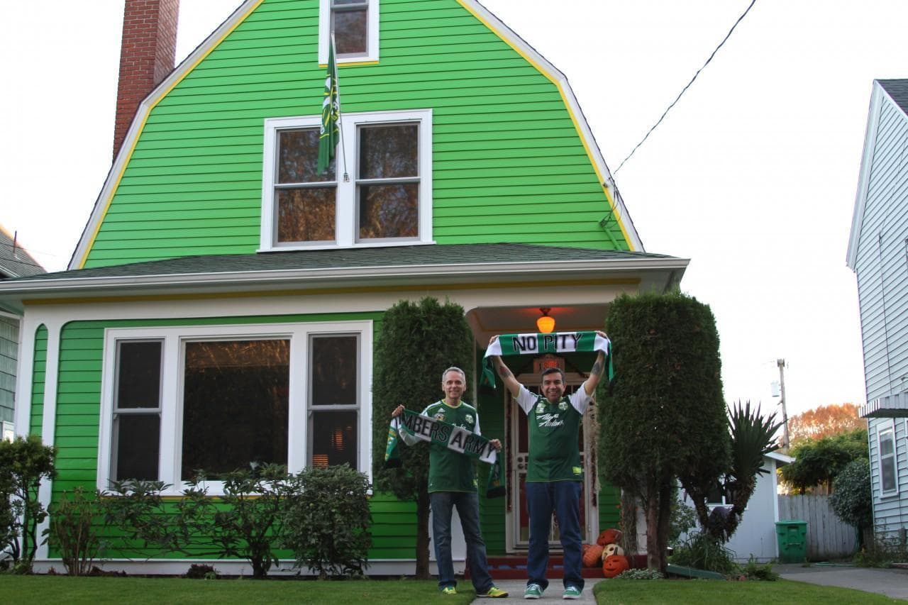 John Halseth (left) and Robin Castro live in Northeast Portland. The couple's so enthusiastic about the Portland Timbers that they painted their house &quot;Timbers' green.&quot; (Conrad Wilson/Only A Game)