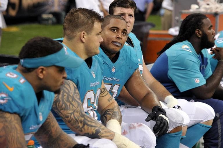 Miami Dolphins guard Richie Incognito (68) and tackle Jonathan Martin (71) look up from the bench in the second half of an NFL football game against the New Orleans Saints in New Orleans, Monday, Sept. 30, 2013.  Martin has resigned from the team because of alleged harassment by Incognito and other members of the team. (AP)