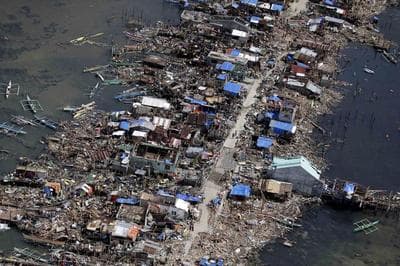 This Monday, Nov. 11, 2013 file aerial photo taken from a Philippine Air Force helicopter shows the devastation of the first landfall by typhoon Haiyan in Guiuan, Eastern Samar province, central Philippines. Haiyan slammed the island nation with a storm surge two stories high and some of the highest winds ever measured in a tropical cyclone. (AP)