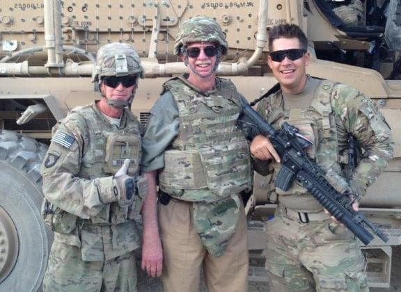 Jeff Traylor, a 71-year-old contractor in Afghanistan (center), flanked by two servicemen. (Jeff Traylor)