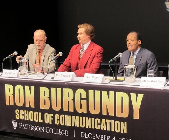 Will Ferrell speaks at a press conference as his character from &quot;Anchorman,&quot; Ron Burgundy. Emerson's president, Lee Pelton, is right, while the interim dean of Emerson's School of Communication, Phillip Glenn, is left. (Andrea Shea/WBUR)
