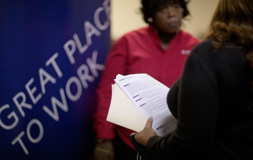 Jimmetta Smith, of Lithonia, Ga., right, the wife of a U.S. Marine veteran, holds her resume while talking with Rhonda Knight, a senior recruiter for Delta airlines, at a job fair for veterans and family members at the VFW Post 2681, in Marietta, Ga, Nov. 14, 2013. (David Goldman/AP)