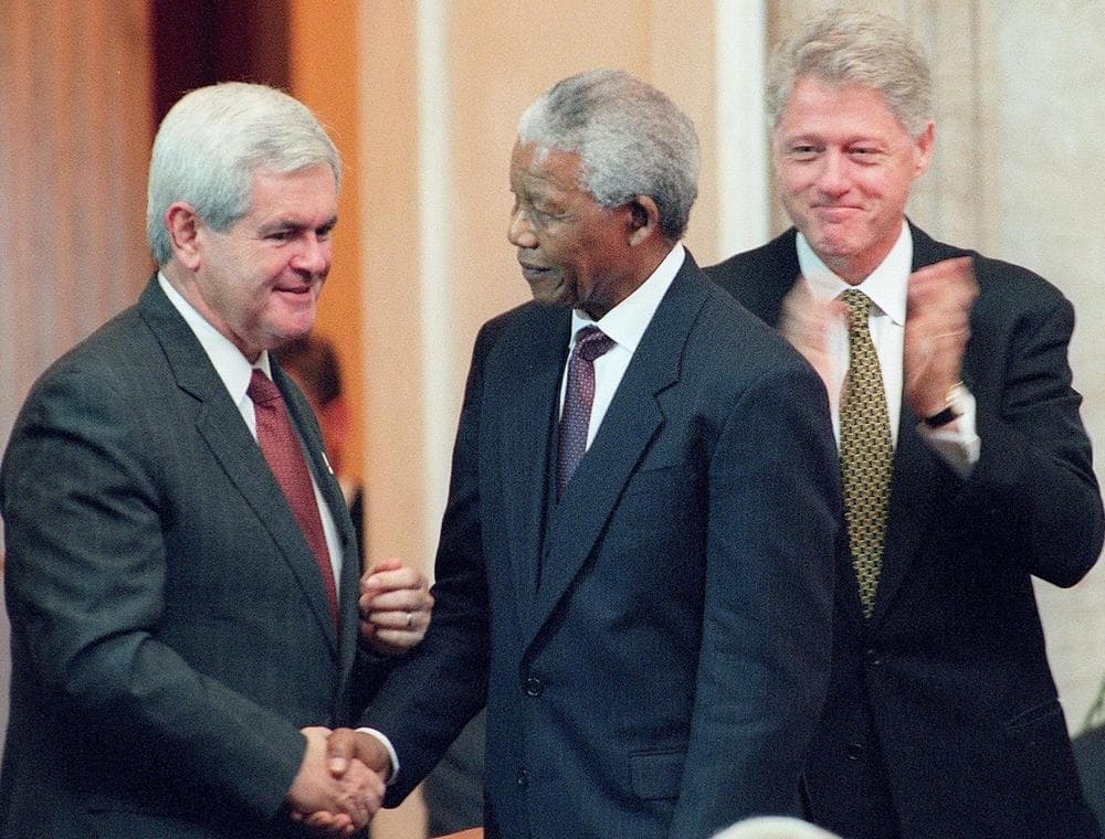South African President Nelson Mandela (center) shakes hands with U.S. Speaker of the House Newt Gingrich (left) as U.S. President Bill Clinton (right) looks on during ceremonies September 23, 1998, in which Mandela received the Congressional Gold Medal on Capitol Hill in Washington, DC. (William Philpott/AFP/Getty Images)