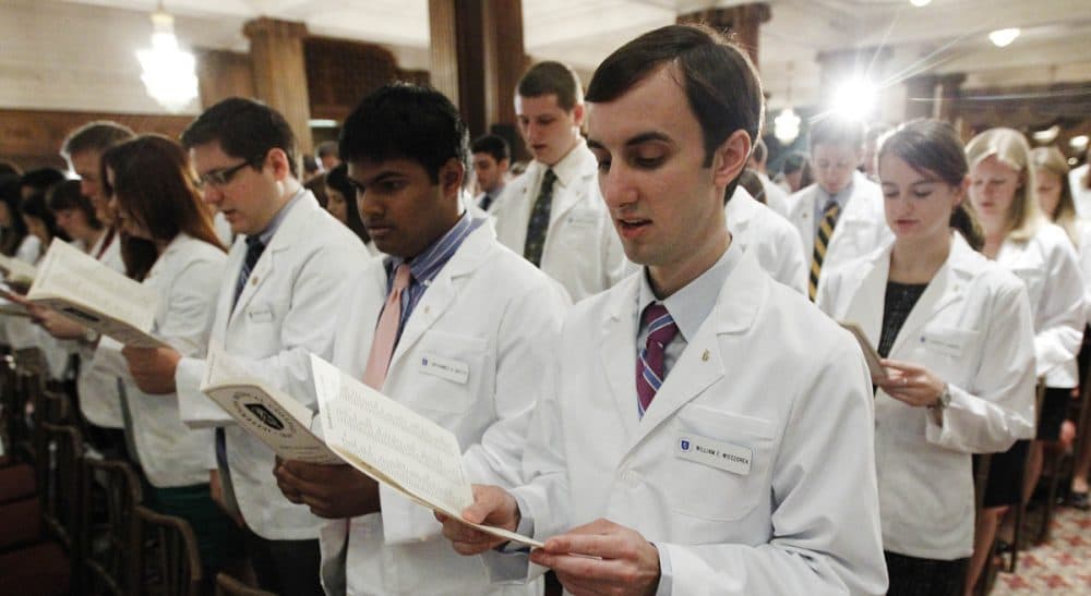 A greater understanding of healthcare economics could lead not just to lower costs -- but to better care.  In this photo, Thomas Jefferson University's Jefferson Medical College first-year student William E. Wieczorek and others take the Hippocratic Oath during the annual White Coat Ceremony, Friday, Aug. 5, 2011, in Philadelphia. (Matt Rourke/AP)