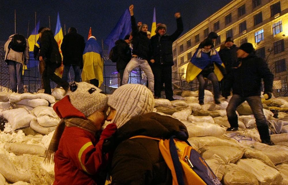 Protesters stand on their newly restored barricade in Kiev's Independence Square, late on December 11, 2013, destroyed earlier by police during a raid on the protest camp. (Sergey Gapon/AFP/Getty Images)