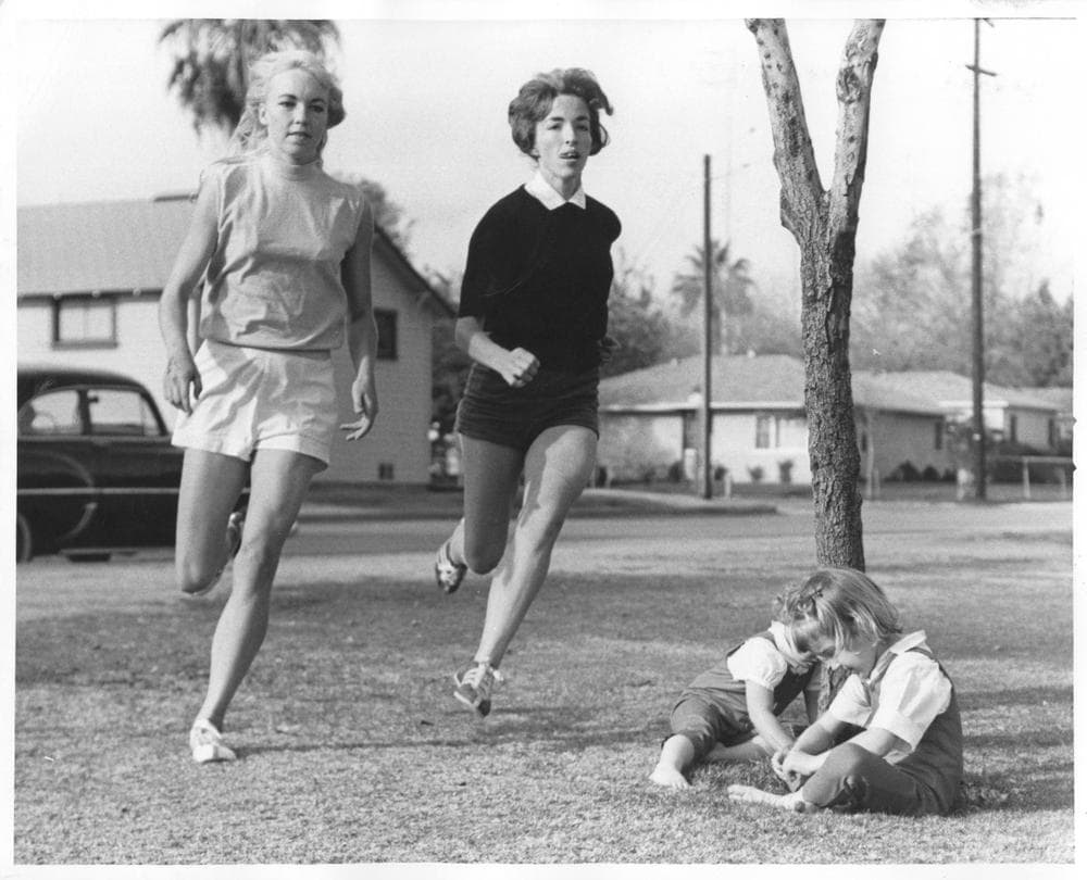 Merry Lepper (left) and Lyn Carman (right) run past Carman's children just days after the 1963 marathon.