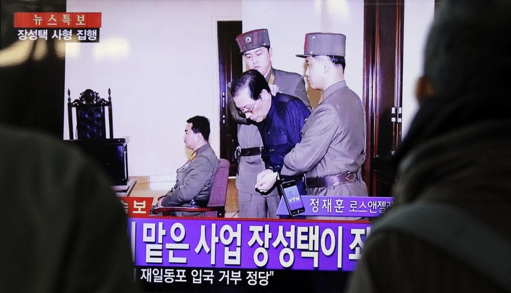 People watch television news showing Jang Song Thaek in court before his execution on December 12, 2013, at the rail station in Seoul on December 13, 2013. (Woohae Cho/AFP/Getty Images)