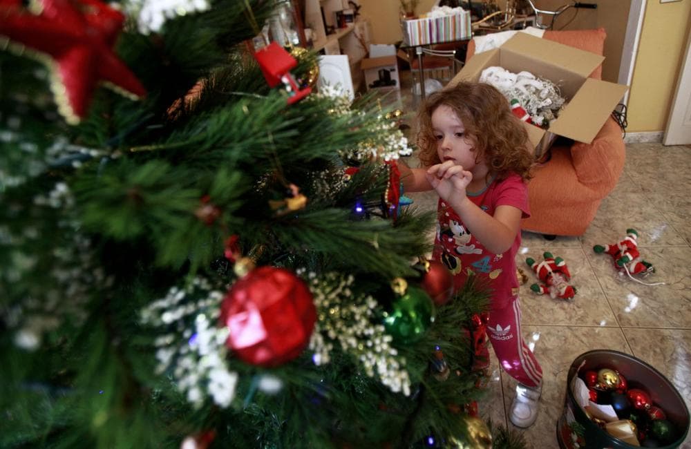 Four-year old Vera Martin prepares the Christmas tree at her home on the Spanish Canary island of Tenerife on December 8, 2013. (Desiree Martina/AFP/Getty Images)