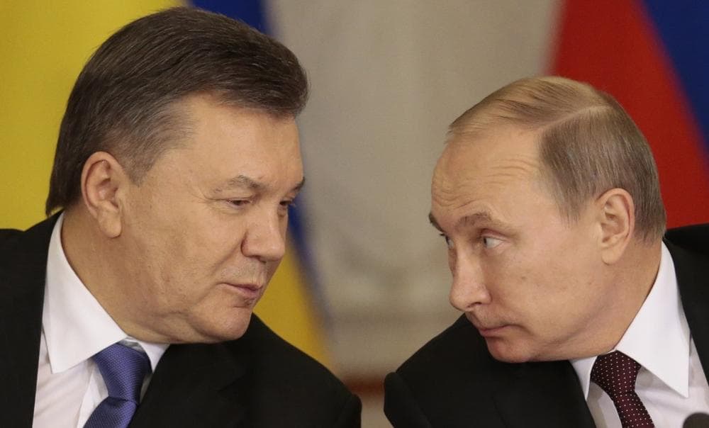 Russian President Vladimir Putin, right, and his Ukrainian counterpart Viktor Yanukovych chat during a news conference after their talks in Moscow on Tuesday, Dec. 17, 2013. (AP Photo/Ivan Sekretarev)