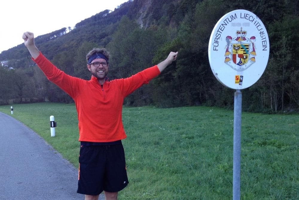 Andrew Evans is triumphant at the border after running nonstop across the length of Liechtenstein (Sandra Thurnheer)