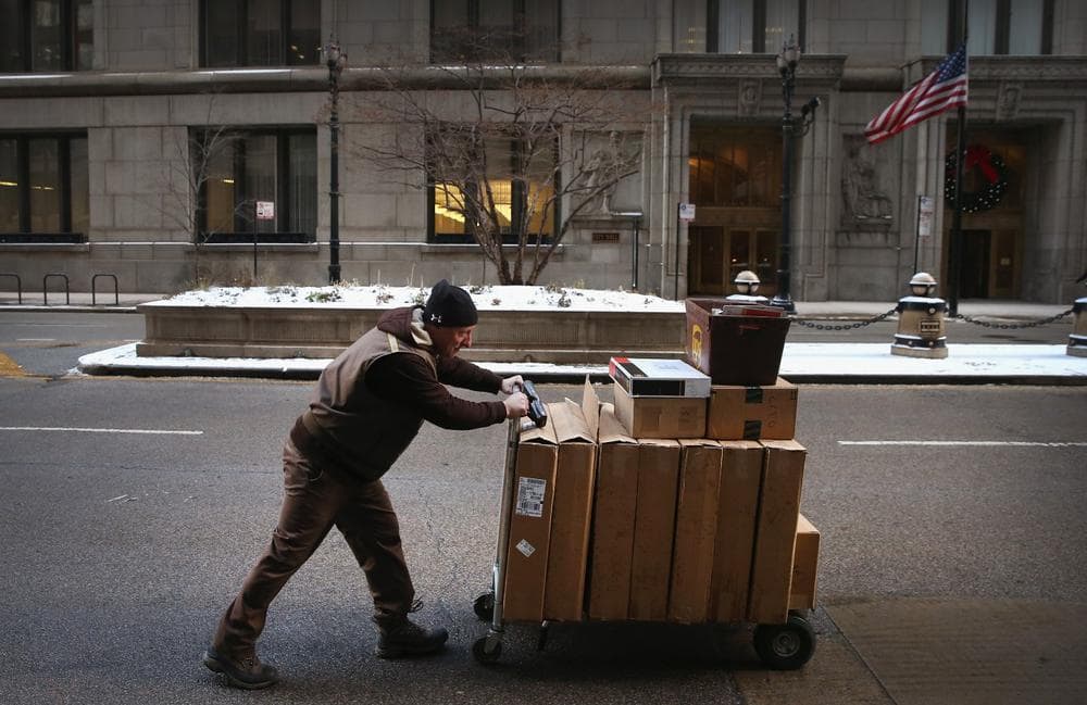  A UPS worker delivers packages on December 26, 2013 in Chicago, Illinois. Bad weather and a higher than expected demand from online sales caused FedEx and UPS to miss many Christmas delivery deadlines. (Scott Olson/Getty Images)