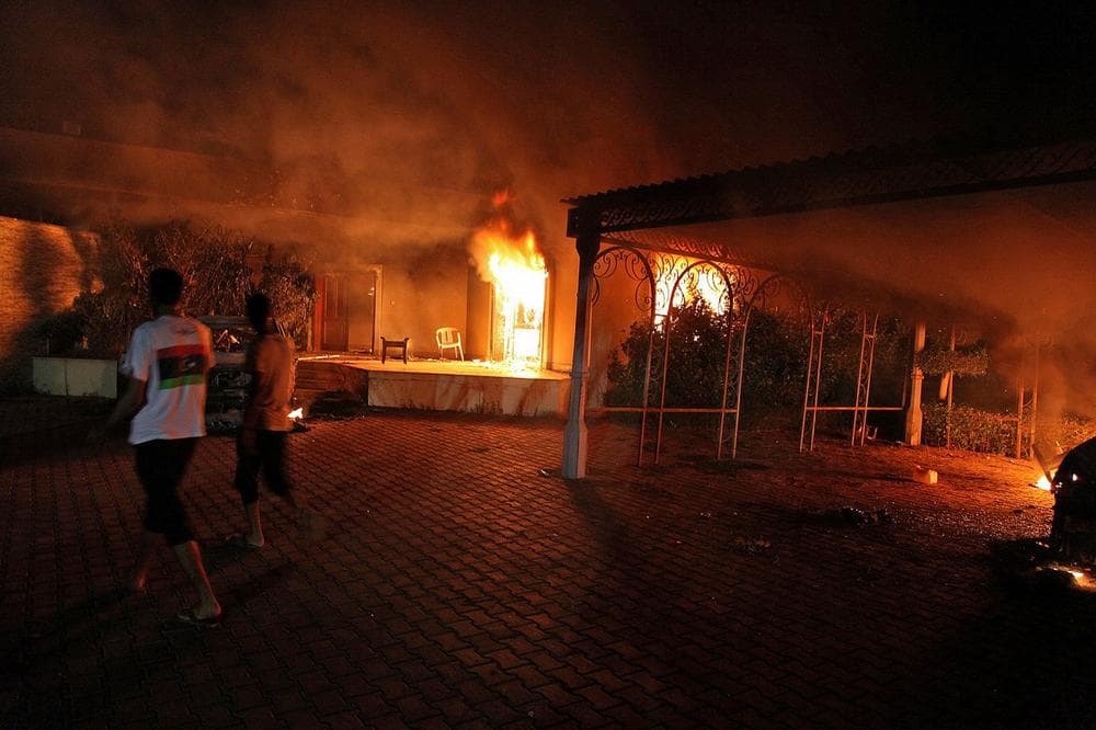 A vehicle (R) and the surround buildings burn after they were set on fire inside the US consulate compound in Benghazi late on September 11, 2012. (STR/AFP/Getty Images)