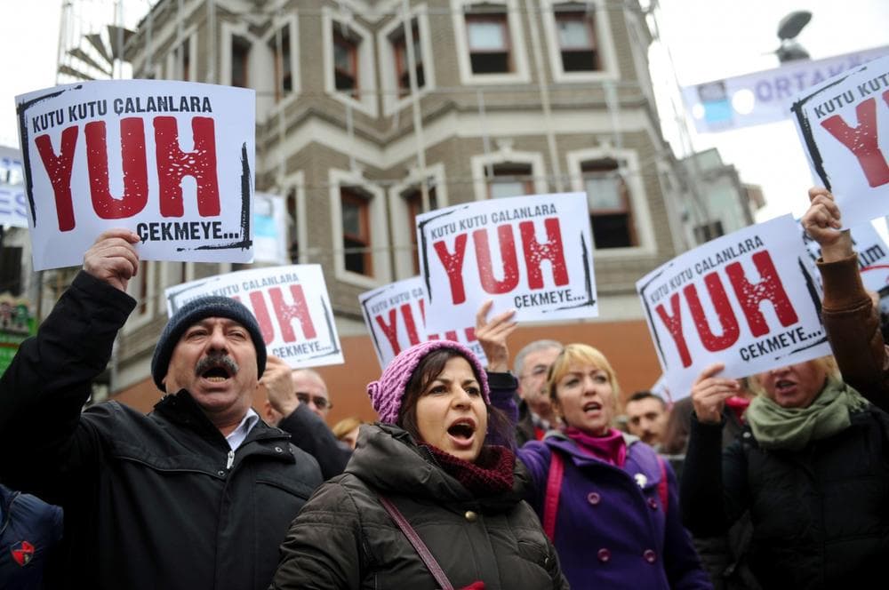 People hold placards reading 'Shame to thieves with Boxes' during a demostration on December 29, 2013 in Istanbul against corruption and the Government. Turkish Prime Minister Recep Tayyip Erdogan lashed out at the judiciary as he tried to tamp down a corruption probe that has shaken his government and sparked a new wave of anti-government protests. (Ozan Kose/AFP/Getty Images)