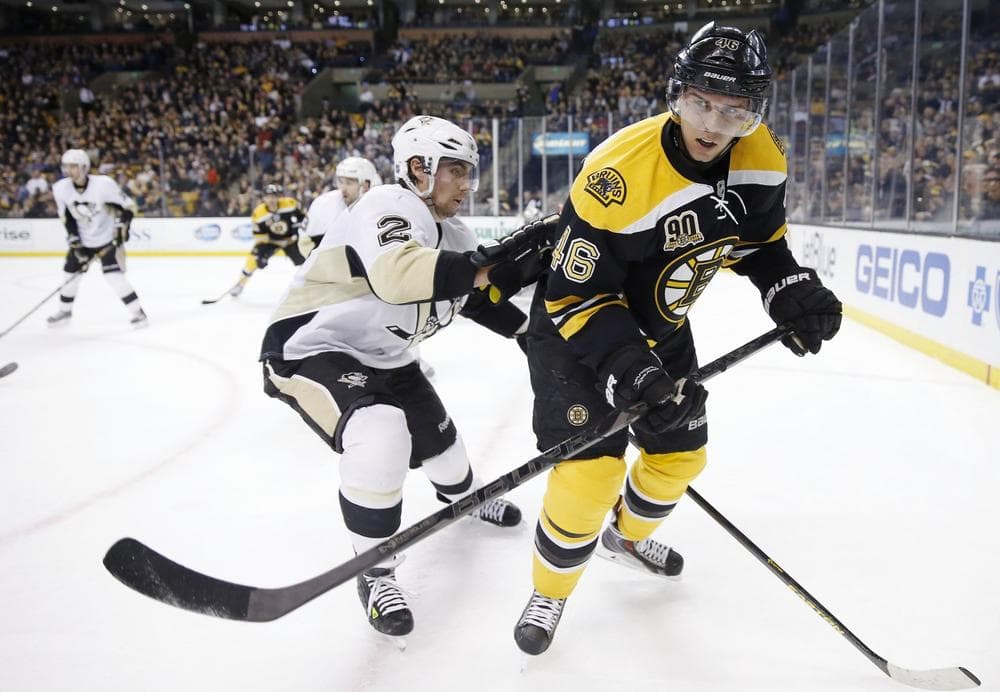 Boston Bruins' David Krejci (46) and Pittsburgh Penguins' Matt Niskanen (2) skate in the second period of an NHL hockey game in Boston, Saturday, Dec. 7, 2013. (AP Photo/Michael Dwyer)