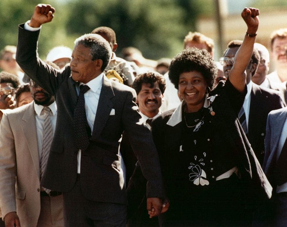 In this Feb. 11, 1990 file photo, Nelson Mandela, left, and his wife, Winnie, walk out of the Victor Verster prison in Paarl, near Cape Town, South Africa, after Mandela had spent 27 years in jail.  (Greg English/AP)