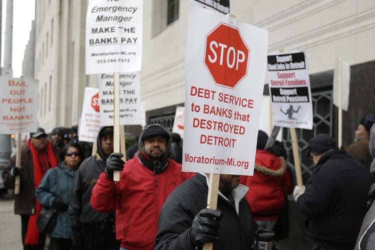 Detroit city workers and supporters protest outside the federal courthouse in Detroit while awaiting the bankruptcy decision, Tuesday, Dec. 3, 2013. Judge Steven Rhodes announced Tuesday that the city the biggest city in U.S. history to enter bankruptcy. (AP)