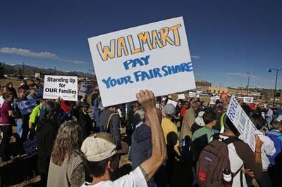 Colorado Walmart employees and supporters join nationwide protests, in front of a Walmart store in Lakewood, Colo., Friday, Nov. 29, 2013, for Walmart to publicly commit to improving labor standards. Black Friday, the day after Thanksgiving, is the nation's biggest shopping day of the year. (AP)