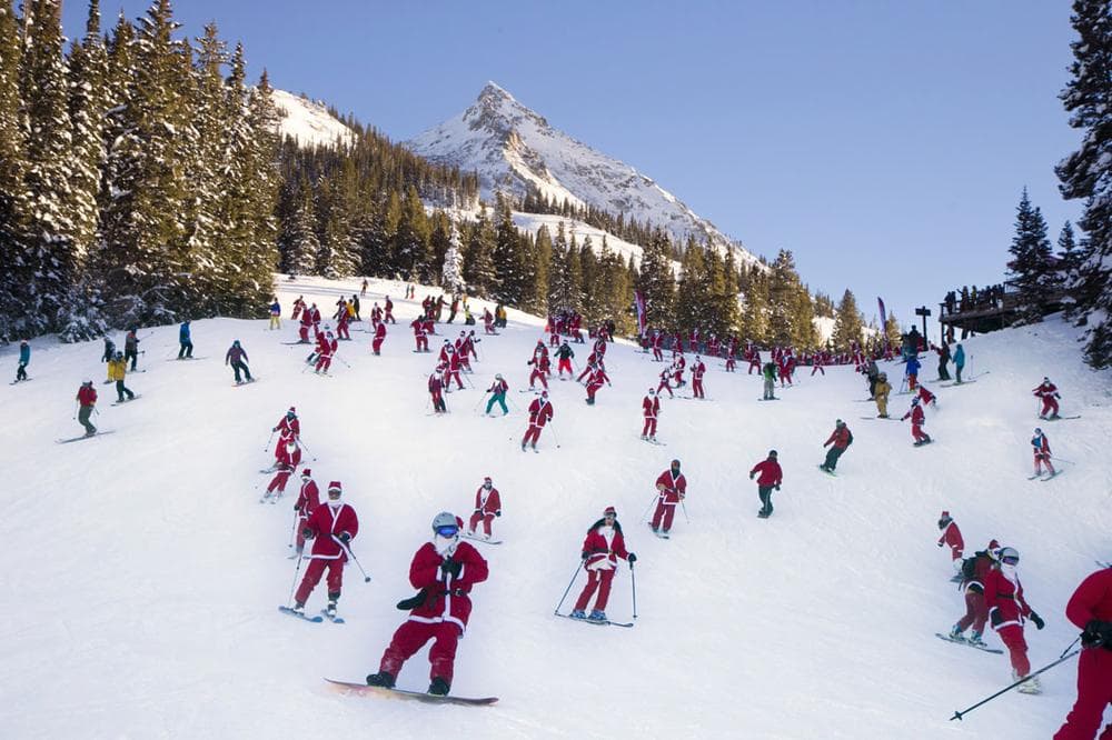 More than 425 people dressed as Santas participated in the “Santa Ski Crawl” skiing from Uley's Ice Bar at Crested Butte Mountain Resort in Colorado on Dec. 14, 2013. (AP Photo/Crested Butte Mountain Resort, Nathan Bilow)
