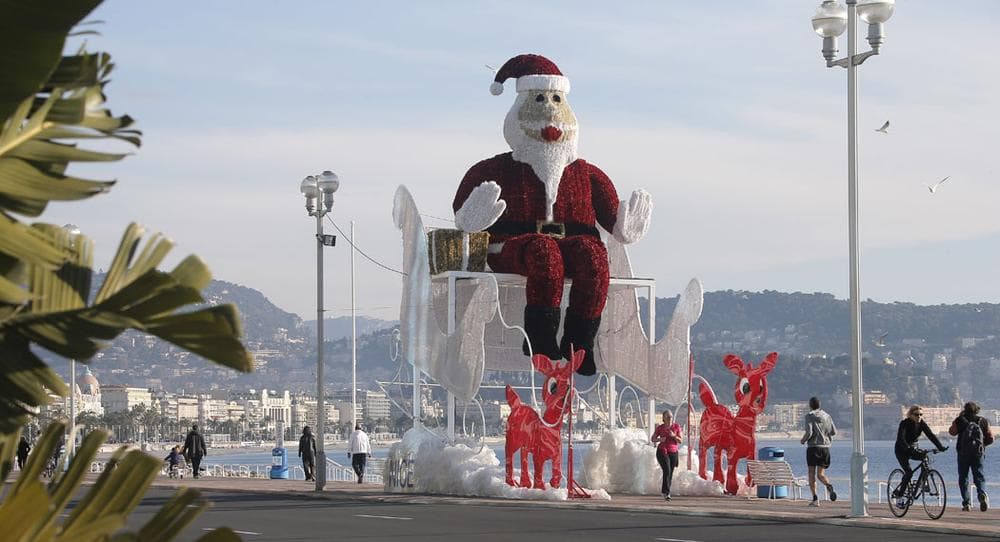 A giant Santa Claus sits in his sleigh on the Promenade des Anglais in Nice, France, on Dec. 14, 2013. (AP Photo/Lionel Cironneau)