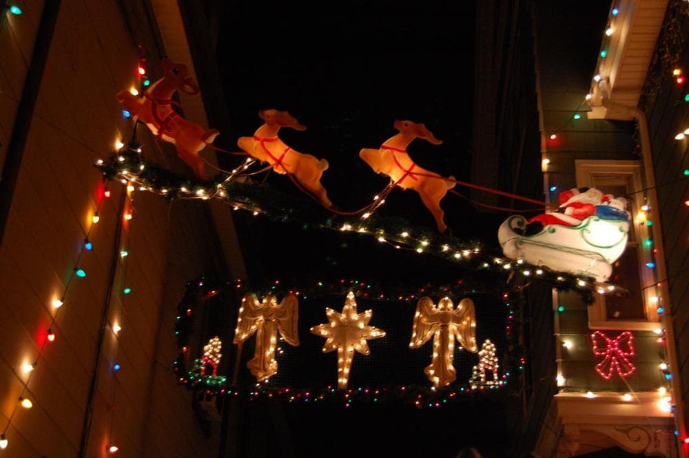 Reindeer pull Santa's sleigh over John Ragno's driveway on Otis Street in Somerville. (Greg Cook)