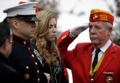 Erin Vasselian, wife of fallen Marine Sgt. Daniel Vasselian, watches as a Marine Honor Guard removes her husband's casket from a hearse at St. Bridget Catholic Church in Abington Thursday, Jan. 2. The 27-year-old was killed in combat in Afghanistan on Dec, 23, 2013. (Stephan Savoia/AP)