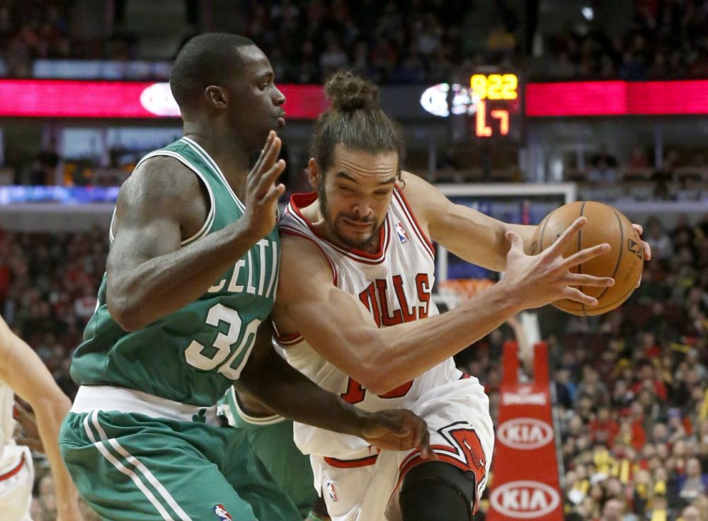 Chicago Bulls center Joakim Noah, right, drives against Boston Celtics forward Brandon Bass, (Charles Rex Arbogast/AP)