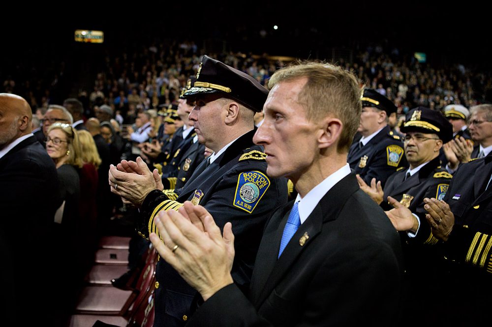 Police Commissioner William Evans, right, applauds during Mayor Marty Walsh's inaugural address. (Jesse Costa/WBUR)