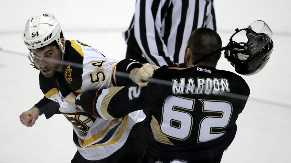 Bruins defenseman Adam McQuaid, left, and Anaheim Ducks' Patrick Maroon brawl during the second period. (AP/Chris Carlson)