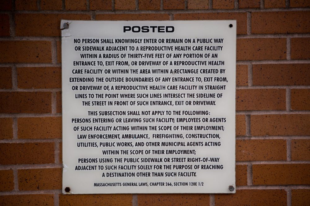 A sign posted on the wall of Planned Parenthood informs people about the 35-foot buffer zone law. (Jesse Costa/WBUR)
