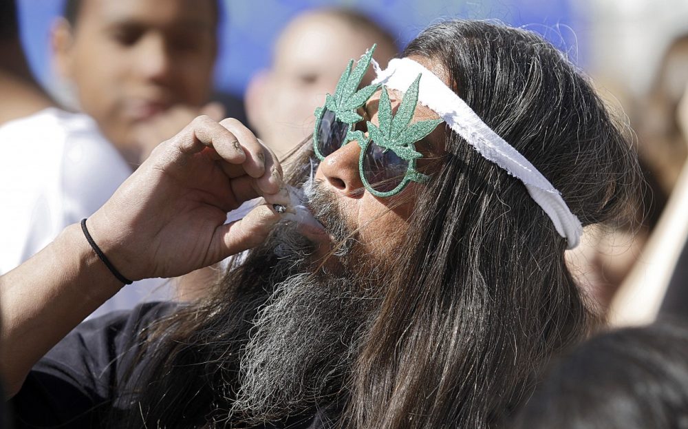 Fast Eddy Aki'a of Hawaii smokes a joint as thousands gathered to celebrate the state's medicinal marijuana laws and collectively light up at 4:20 p.m. in Civic Center Park April 20, 2012 in Denver, Colorado. (Marc Piscotty/Getty Images)