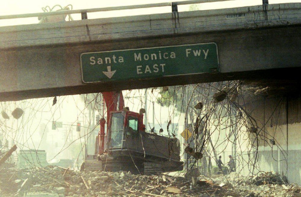 A bulldozer begins to tear down a section of the Santa Monica Freeway, Jan. 19, 1994, that collapsed during the Northridge earthquake. (Tim Clary/AFP/Getty Images)