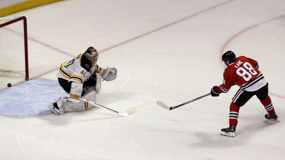 Chicago Blackhawks' Patrick Kane, right, scores against Boston Bruins goalie Tuukka Rask during Sunday's shootout. (Nam Y. Huh/AP)