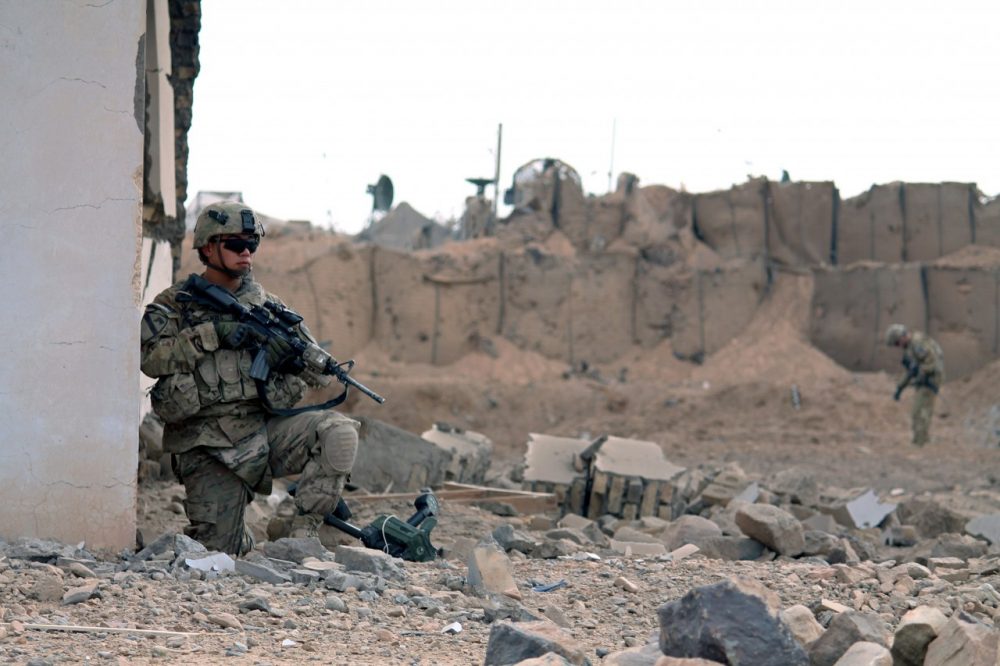 U.S. soldiers inspect the scene of a suicide attack outside a base in Zhari district, Kandahar province on January 20, 2014. (Javed Tanveer/AFP/Getty Images)