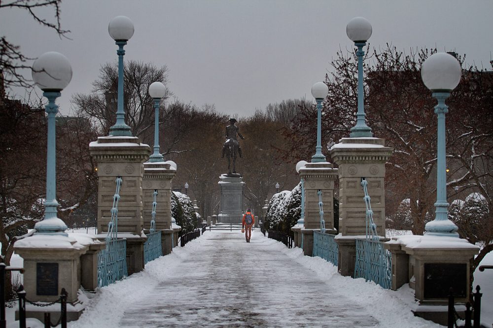 Man walking across the bridge in the Boston Public Gardens towards Commonwealth Ave.  (Jesse Costa/WBUR)