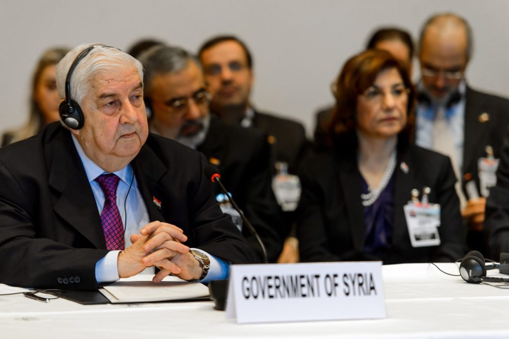 Syrian Foreign Minister Walid Muallem (L) and his delegation take part in the Geneva II peace talks on January 22, 2014 in Montreux. Representatives of Syrian President Bashar al-Assad, a deeply divided opposition, world powers and regional bodies started a long-delayed peace conference aimed at bringing an end to a nearly three-year civil war. (Fabrice Coffrini/AFP/Getty Images)