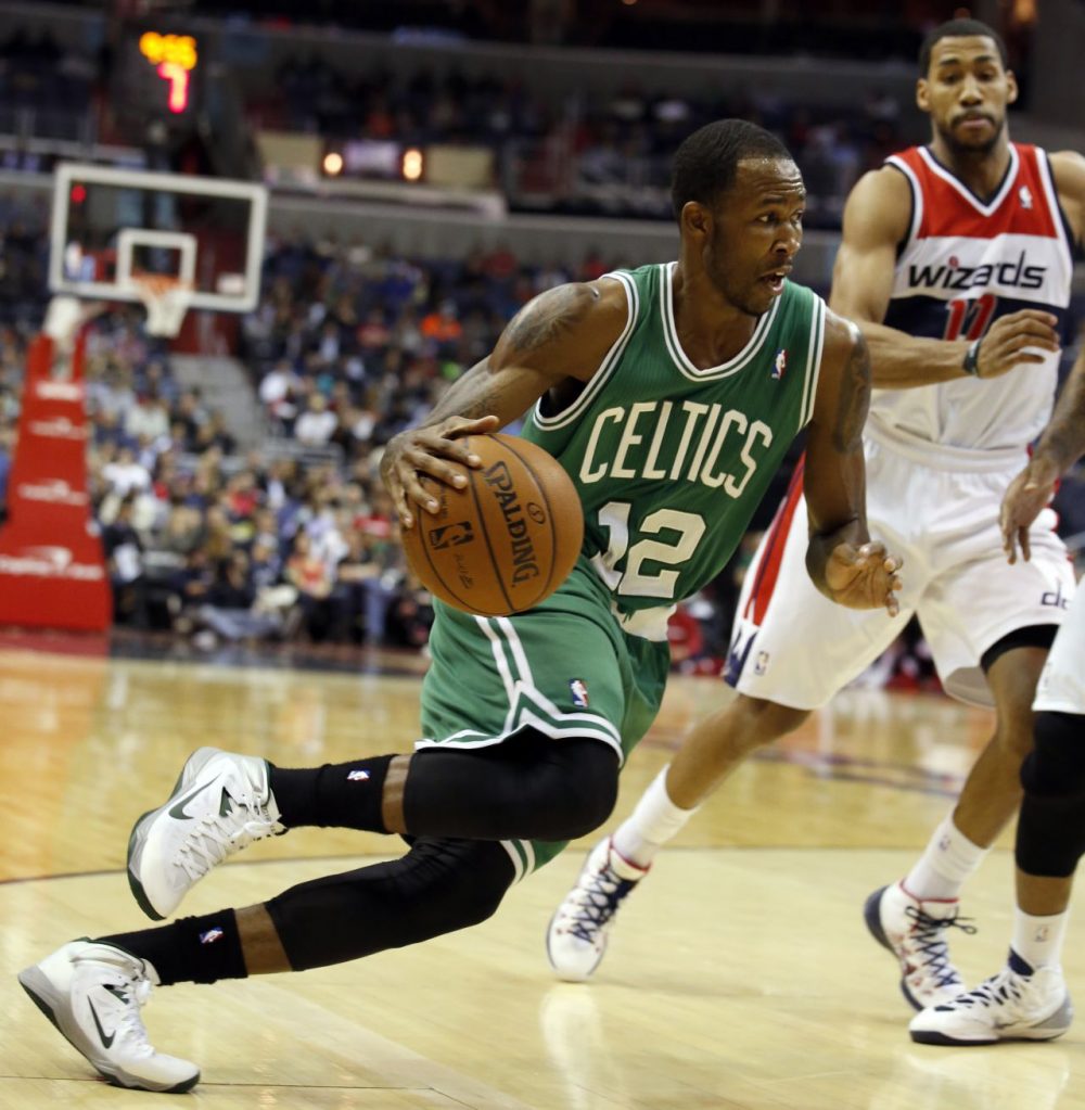 Boston Celtics forward Chris Johnson (12) drives past Washington Wizards guard Garrett Temple (17). (AP/Alex Brandon)