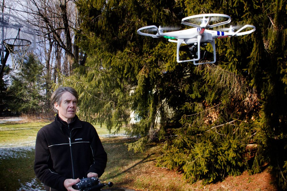 Entrepreneur Terry Holland operates his “quadcopter” unmanned aerial vehicle outside his Pittsfield home. (Jesse Costa/WBUR)