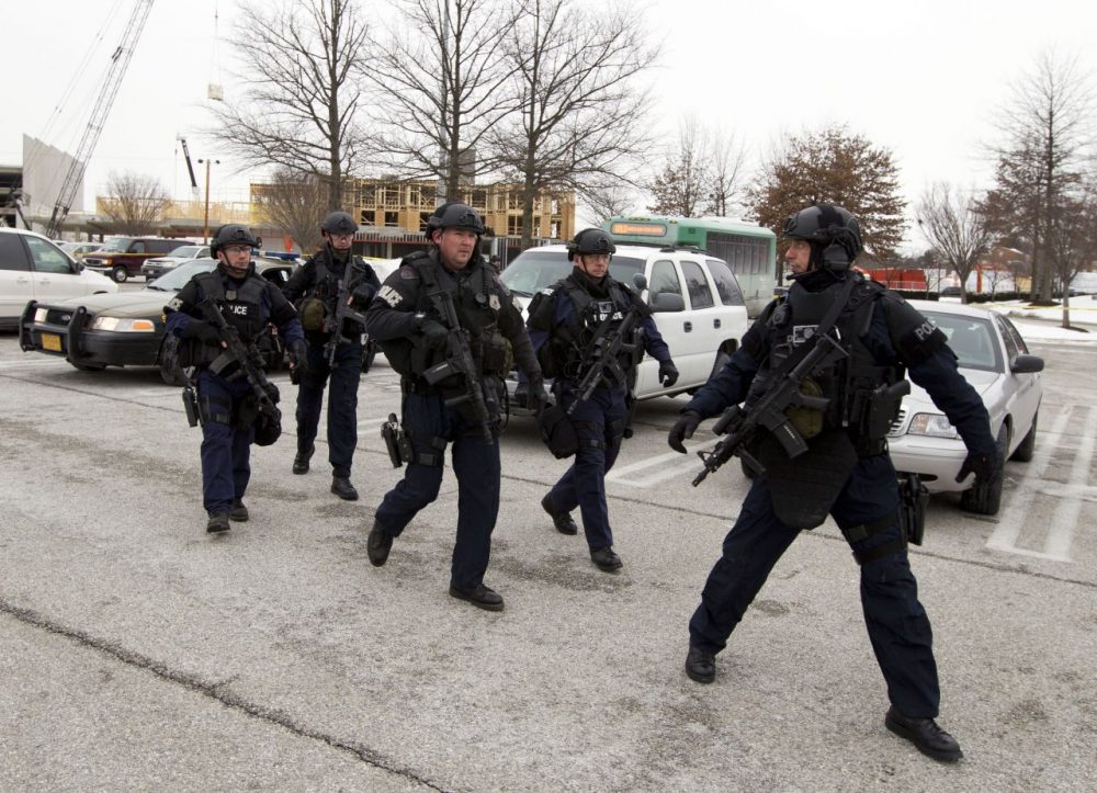 Police move in from a parking lot to the Mall in Columbia on Saturday. (Jose Luis Magana/AP)