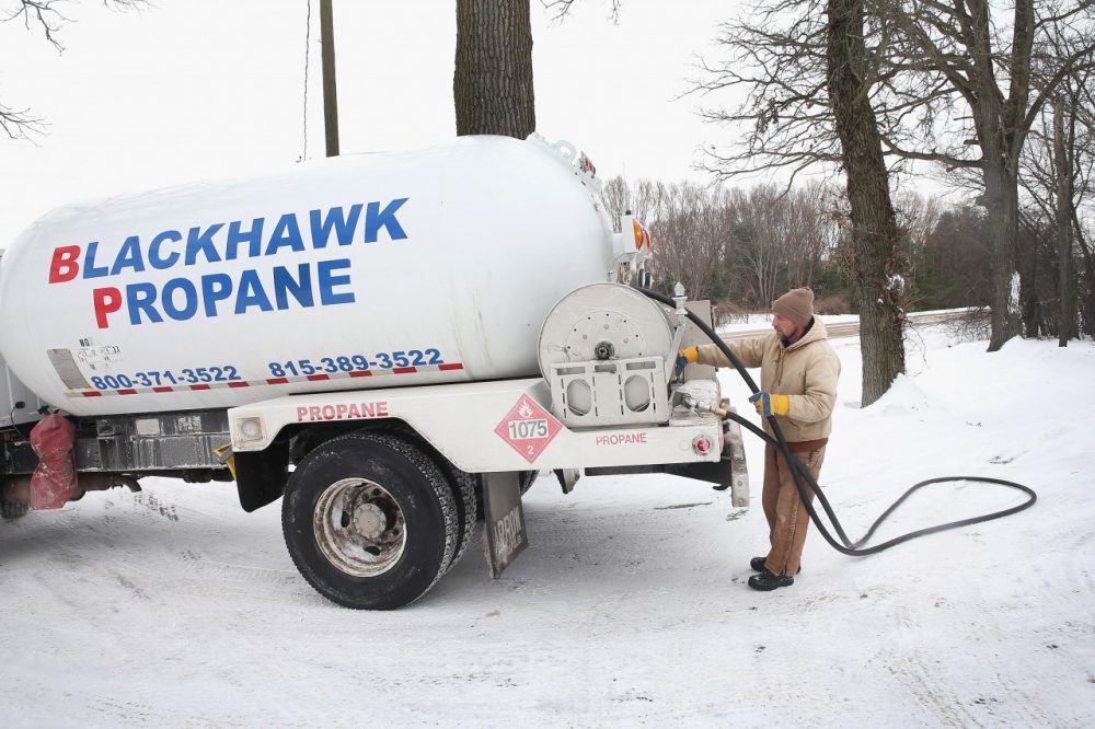 Mark Burger of Blackhawk Propane delivers propane to a rural home on January 24, 2014 near Clinton, Wisconsin. A shortage of propane in the Midwest has caused prices to surge upwards to near $5 a gallon in some markets. (Scott Olson/Getty Images)