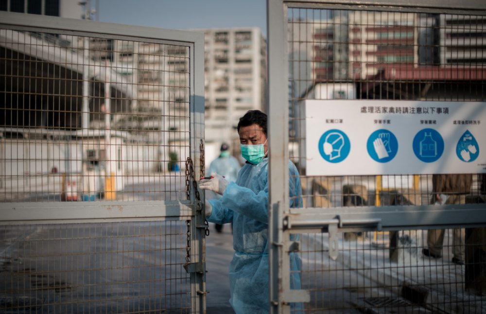 A security guard closes the gate of a live poultry market in Cheung Sha Wan before officials proceed to cull chickens in Hong Kong on January 28, 2014. Hong Kong began a mass cull of 20,000 chickens after the deadly H7N9 bird flu virus was discovered in poultry imported from mainland China, authorities said. (Phillipe Lopez/AFP/Getty Images)