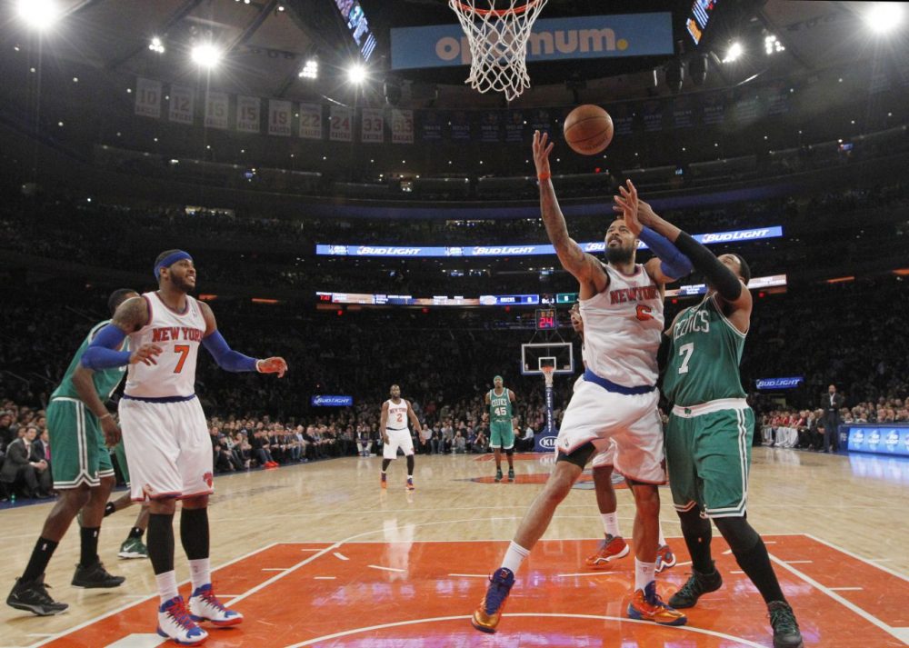 New York Knicks forward Tyson Chandler (6) pulls down a rebound as he battles with Boston Celtics center Jared Sullinger (7) as Knicks forward Carmelo Anthony (7) watches. (AP/Kathy Willens)