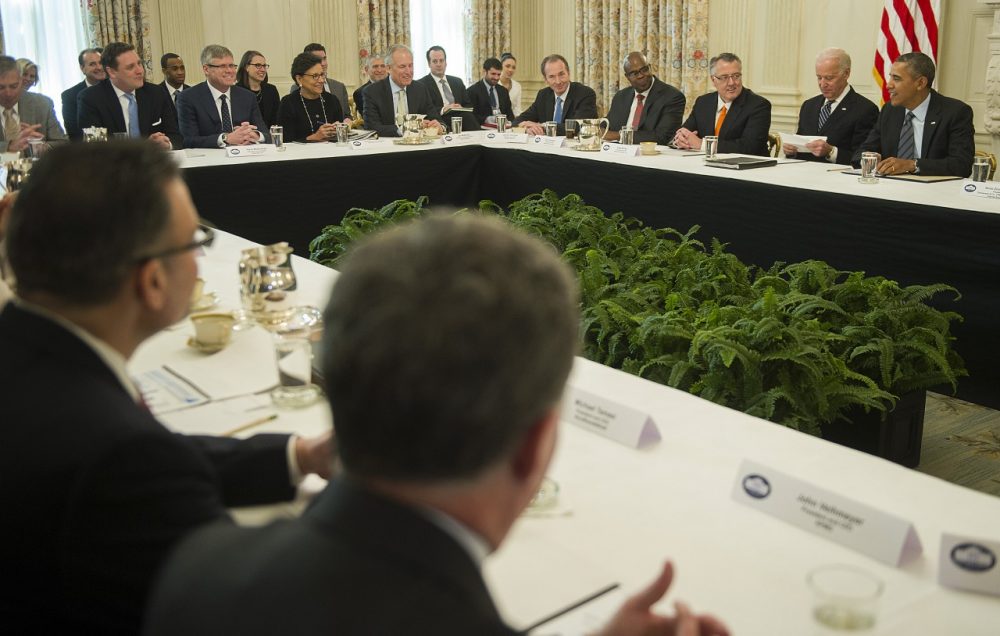 U.S. President Barack Obama and Vice President Joe Biden meet with a group of CEOs and other leaders supporting best practices for hiring the long-term unemployed at the White House in Washington, DC, January 31, 2014. (Jim Watson/AFP/Getty Images)