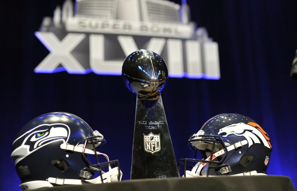 The Vince Lombardi Trophy and helmets for the Seattle Seahawks and  Denver Broncos are displayed prior to a Super Bowl XLVIII head coach joint press conference at the Rose Theater in Jazz at Lincoln Center on January 31, 2014 in New York. (Timothy Clary/AFP/Getty Images)