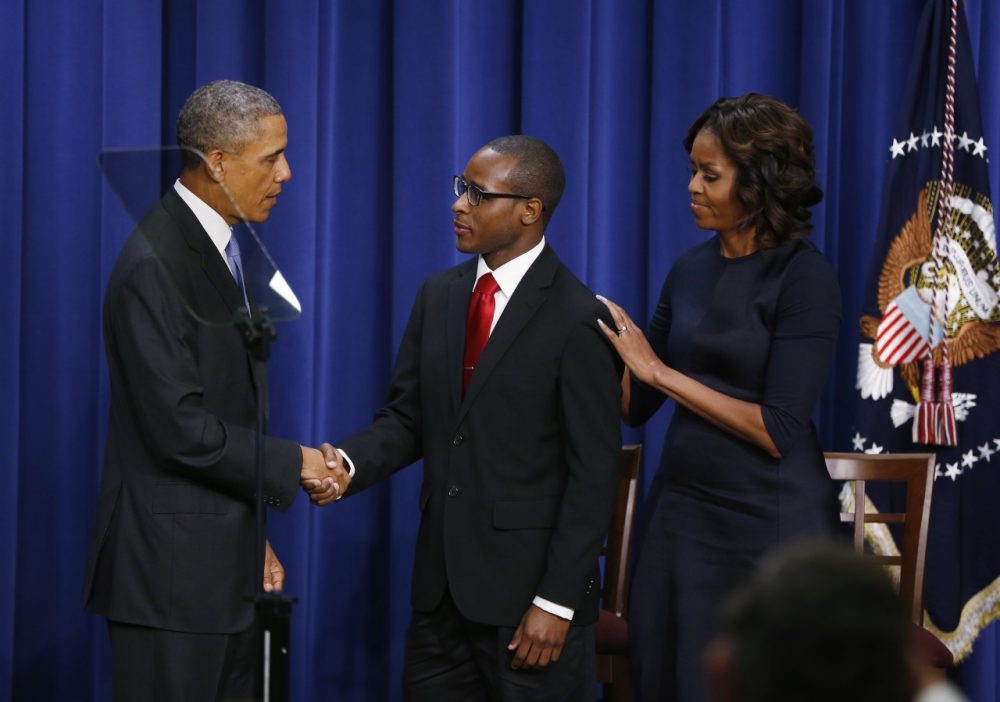 President Barack Obama and first lady Michelle Obama shake hands with Troy Simon, a New Orleans native who couldn't read until he was 14, and college graduate, after Obama spoke about college education at the Eisenhower Executive Office Building across from the White House in Washington, Thursday, Jan. 16, 2014. The event which is to promote opportunities for students to attend and finish college and university, was attended by college and university presidents and leaders from nonprofits, foundations, governments and businesses. (AP)