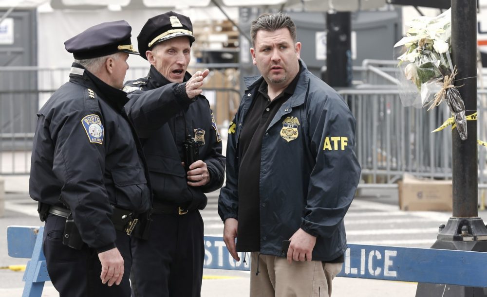 Boston Police Superintendent William Evans, center, talks with an ATF agent at a barricade near the finish line of the Boston Marathon in Boston Tuesday, April 16, 2013. (AP/Winslow Townson)